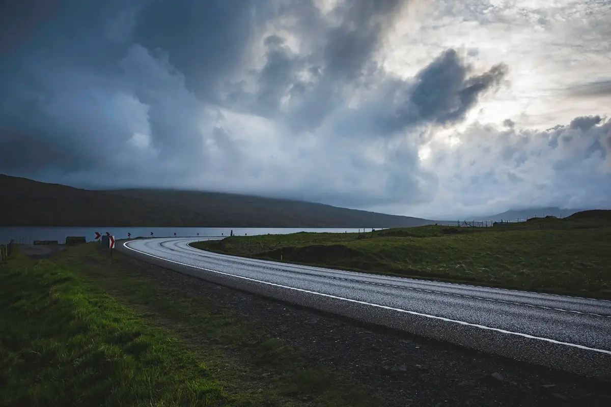 Scenic road on a Sørvágsvatn Faroe Islands scooter ride leading from Sørvágur to Miðvág on a cloudy evening in the Faroe Islands