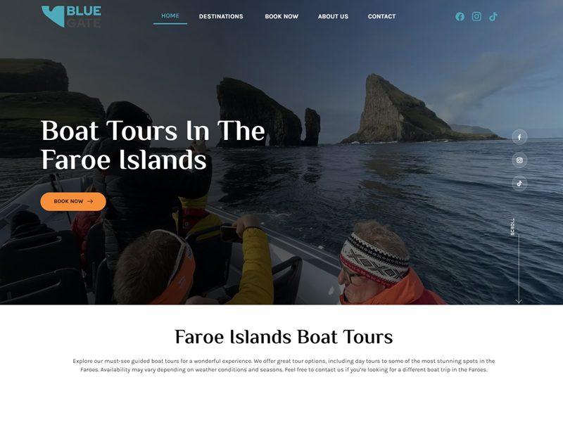 Boat tour passing Drangarnir sea stacks near Vágar Island in the Faroe Islands
