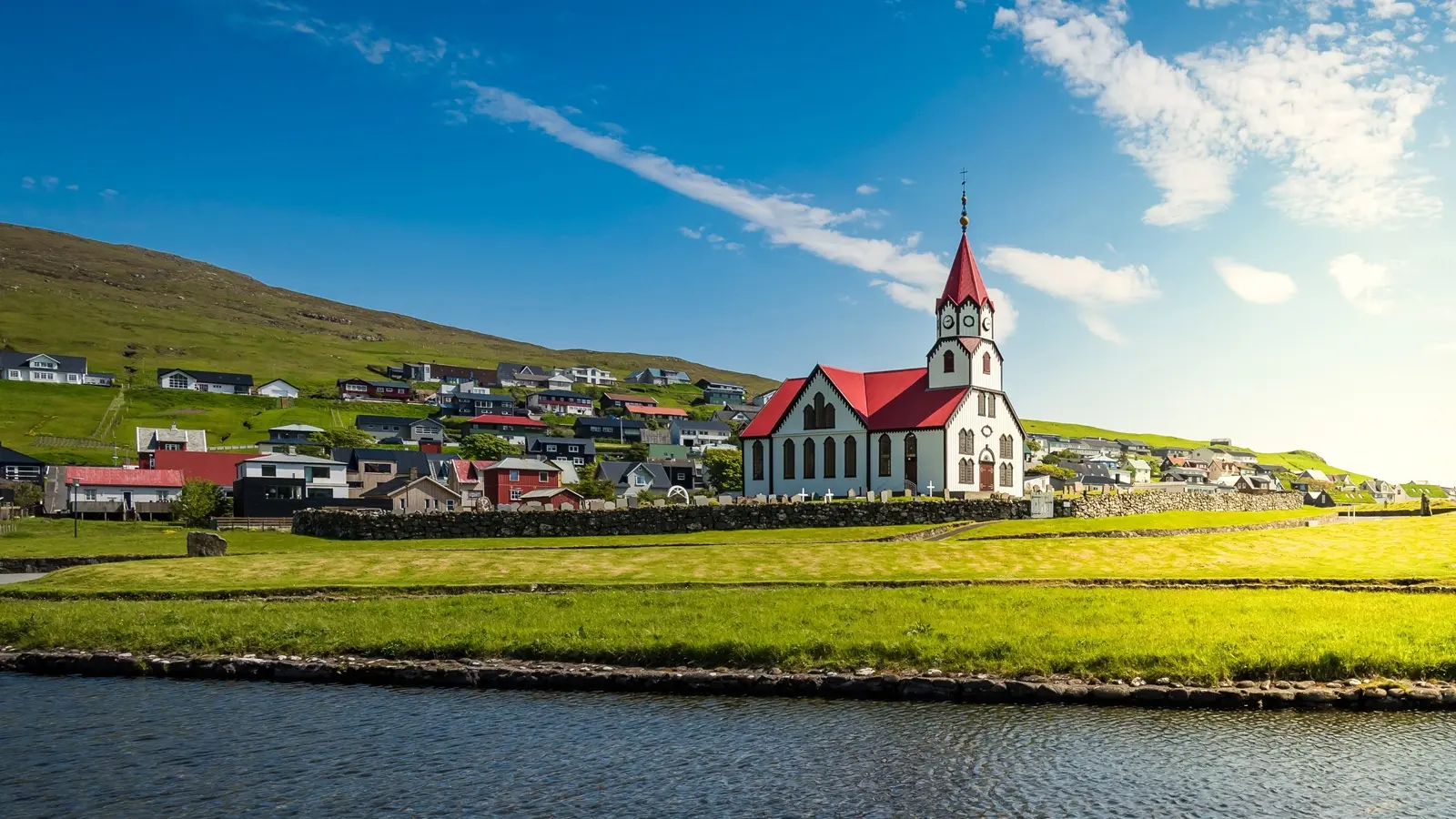 Sandavágur Faroe Islands scooter ride near the red-roof church